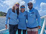 Three researchers standing on a boat, St. Thomas, USVI. Credit - NOAA